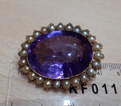 Lot 2135 - An Amethyst and Split Pearl Brooch the oval...