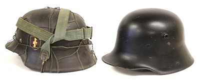 Lot 167 - A German M16 Combat Helmet, with later black...