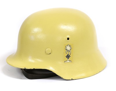 Lot 168 - A German M40 Combat Helmet, with later yellow...