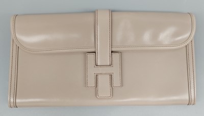 Lot 1227 - A Hermès Jige Taupe Leather Clutch Bag, with...