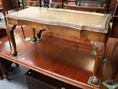 Lot 1251 - A Walnut Coffee Table, on ball and claw feet,...