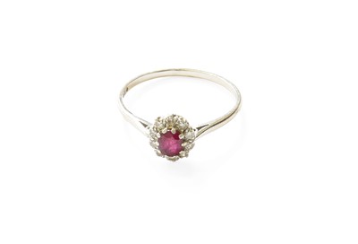 Lot 427 - A Platinum Ruby and Diamond Cluster Ring, the...