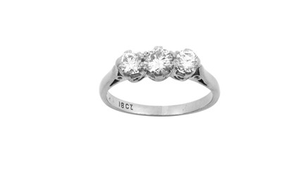 Lot 2167 - A Diamond Three Stone Ring the graduated round...