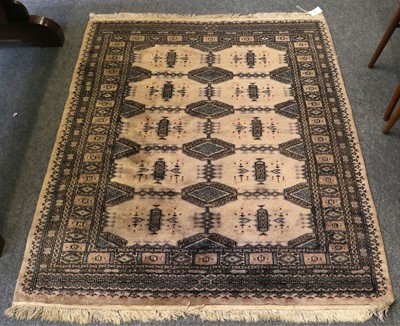 Lot 1118 - "Bukhara" Rug, the cream field with rows of...