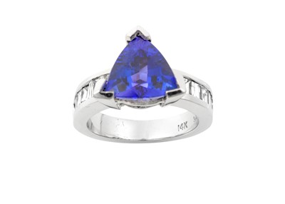 Lot 2245 - A Tanzanite and Diamond Ring the trilliant cut...