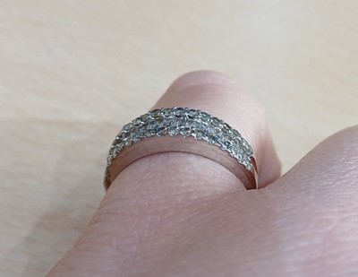 Lot 2062 - A Diamond Half Hoop Ring a row of tapered...