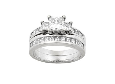 Lot 2318 - A Diamond Three Stone Ring and A Diamond Half...