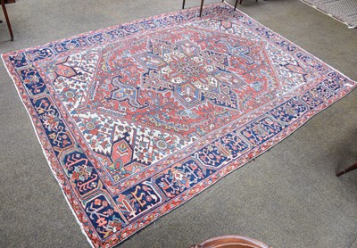 Lot 1102 - Heriz Carpet, the madder field of angular...