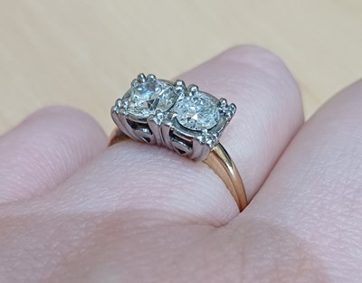 Lot 2060 - A Diamond Two Stone Ring the round brilliant...