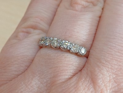 Lot 2064 - An 18 Carat White Gold Diamond Half Hoop Ring...