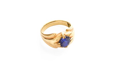 Lot 49 - A Synthetic Sapphire Ring, the round cut...