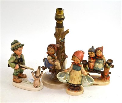 Lot 33 - A Hummel figural table lamp, two Hummel figures and a similar figure