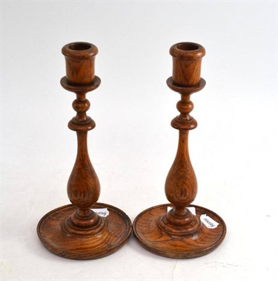 Lot 44 - A pair of early 20th century turned oak candlesticks