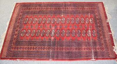 Lot 1025 - "Bukhara" Rug, the blood red field with two...