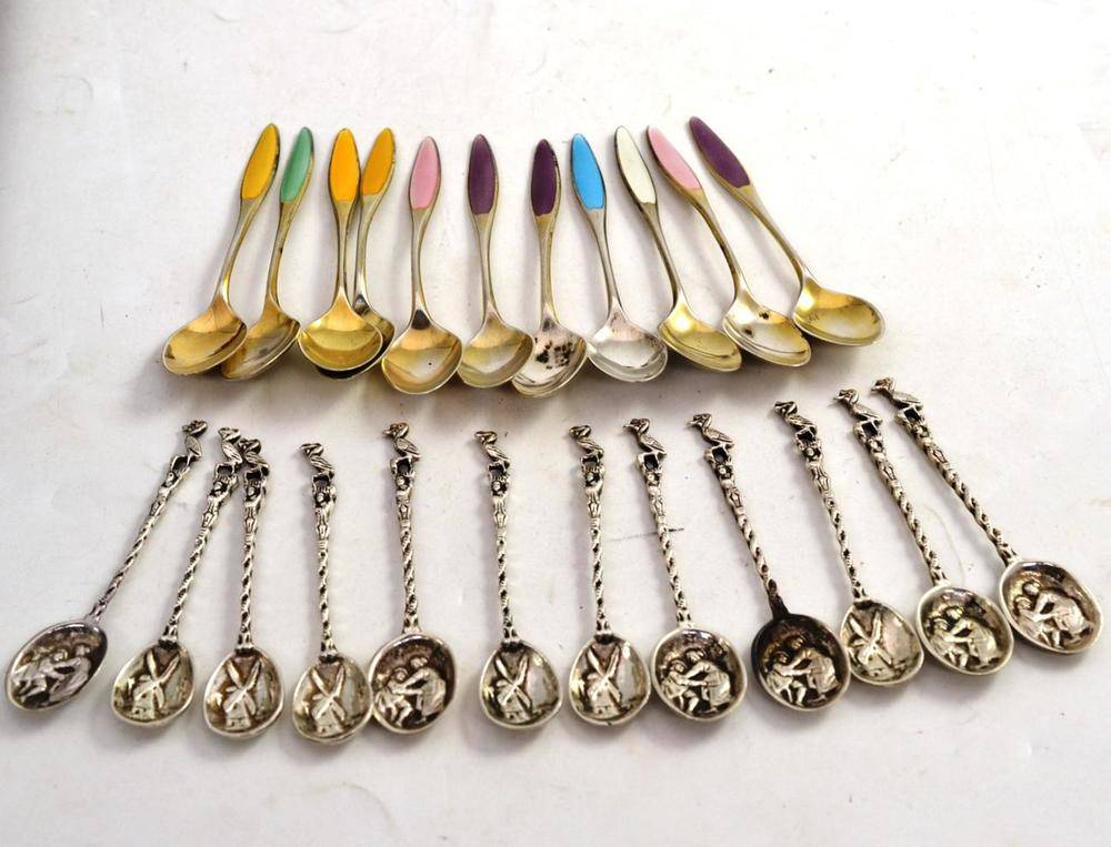 Lot 128 - Eleven enamel teaspoons stamped 'Sterling' and twelve embossed teaspoons stamped '830'