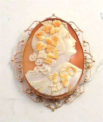 Lot 130 - A cameo brooch depicting Bacchus in a scrollwork frame, stamped '9CT'