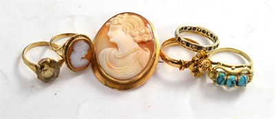 Lot 131 - A gold mounted shell cameo brooch and a ring; and four gold gem set dress rings
