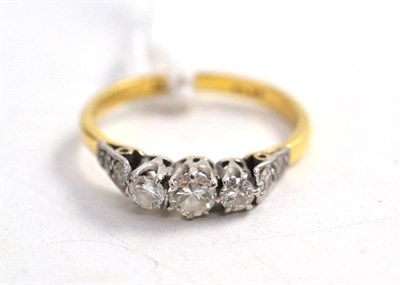 Lot 133 - An 18ct gold and diamond three stone ring with diamond set shoulders