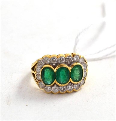 Lot 136 - An emerald and diamond triple cluster ring stamped '18k'