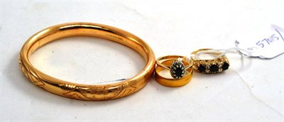 Lot 172 - A 22ct gold ring, a sapphire set ring, a sapphire and diamond cluster ring and a bangle stamped...