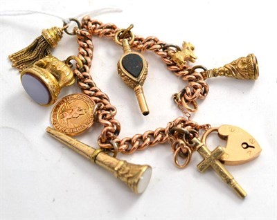 Lot 175 - A charm bracelet hung with eight charms