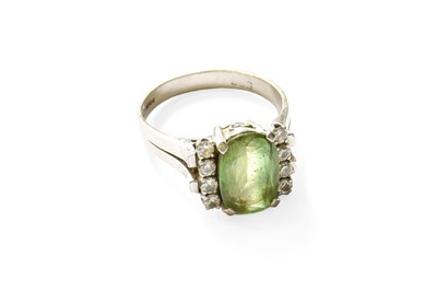 Lot 417 - A 14 Carat White Gold Peridot and Diamond Ring,...