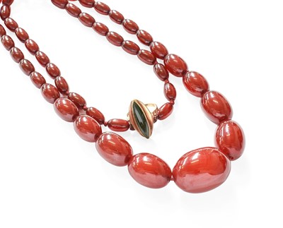 Lot 412 - A Graduated Amber Bead Necklace, length 71cm;...