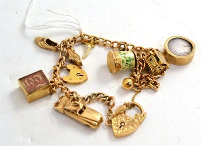 Lot 184 - A 9ct gold link bracelet hung with nine various charms