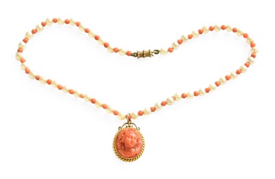 Lot 40 - A Coral Pendant on a Coral and Simulated Pearl...