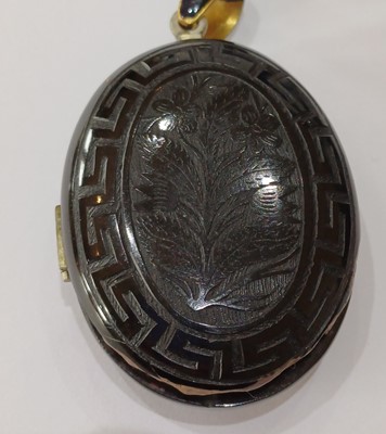 Lot 56 - A Jet Mourning Locket, the locket carved with...