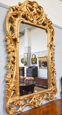 Lot 1223 - A Large Modern Giltwood Wall Mirror, in the...