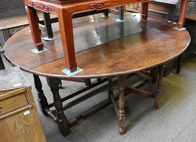 Lot 1249 - An Oak Double Gateleg Dining Table, in the...