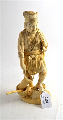 Lot 284 - A Japanese walrus ivory sectional figure of a fisherman with lantern, circa 1910 (small part of...