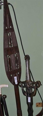 Lot 302 - An African carved wood dance paddle club and an Oriental fantasy sword