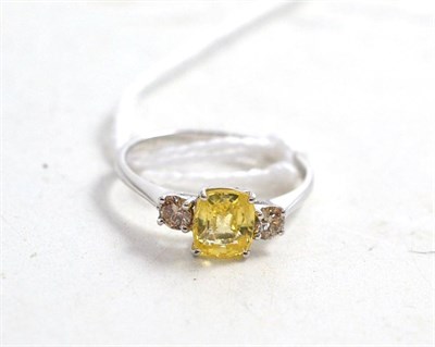 Lot 309 - Yellow sapphire and two stone diamond ring