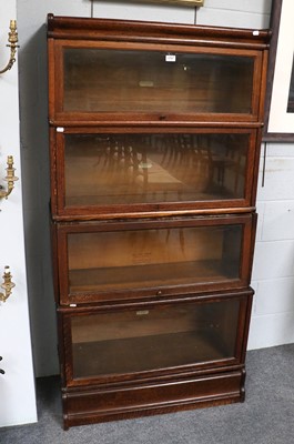 Lot 1197 - An Oak Globe Wernicke Four Tier Stacking...