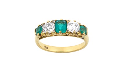 Lot 2200 - An Emerald and Diamond Five Stone Ring three...