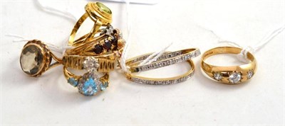 Lot 337 - A three stone ring, probably white sapphires, 9ct shanks, seven various dress rings, one...