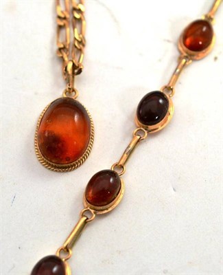 Lot 339 - An amber set bracelet and a figaro link chain with amber pendant