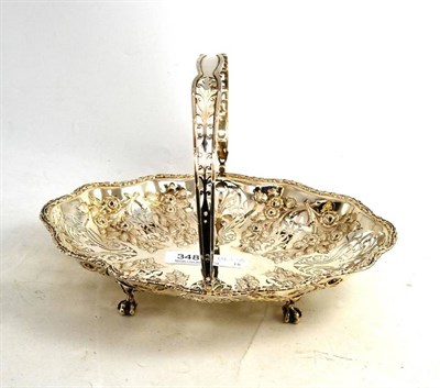 Lot 348 - An Edwardian silver cake basket pierced and embossed with foliage, on four claw and ball feet,...