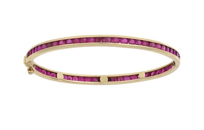 Lot 2092 - A Ruby Hinged Bangle the round cut rubies in...