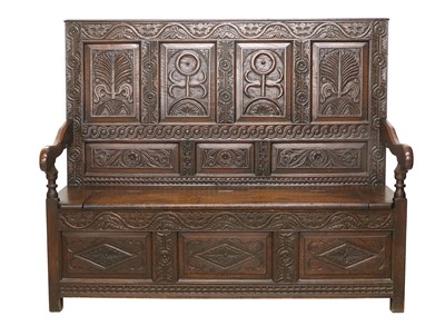 Lot 744 - An 18th Century Carved Oak Box Settle, the...