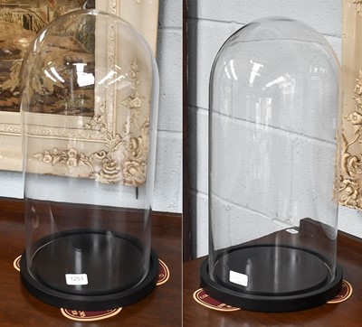 Lot 1251 - A Pair of Modern Circular Glass Domes on...