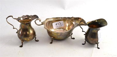 Lot 413 - A silver sauce boat and two cream jugs