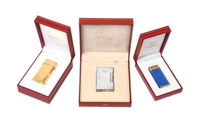 Lot 2252 - A Cartier Gilt Plate Cigarette-Lighter and a Must de Cartier Gold Plate and Enamel Example,`