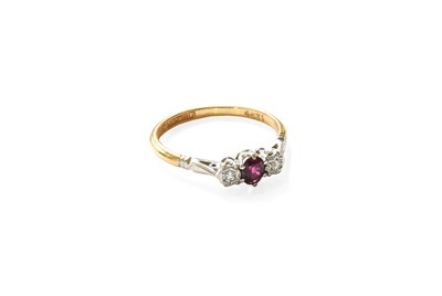 Lot 335 - A Ruby and Diamond Three Stone Ring, the oval...