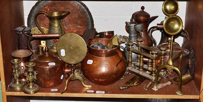 Lot 429 - A shelf of brass and copper including toasting forks, jugs, charger, miner's safety lamp,...