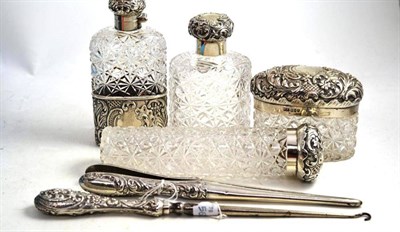 Lot 458 - Three silver topped bottles, spirit flask, button hook and glove stretchers (6)