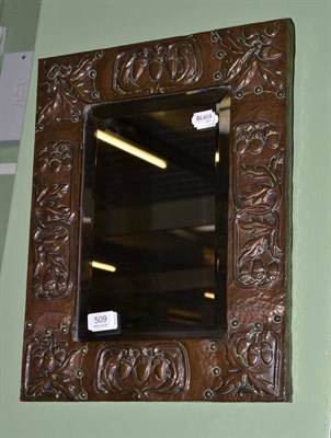 Lot 509 - An Arts & Crafts copper framed mirror embossed with acorns and oak leaves