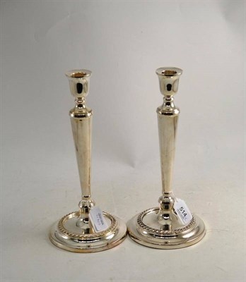 Lot 514 - Pair of loaded silver candlesticks